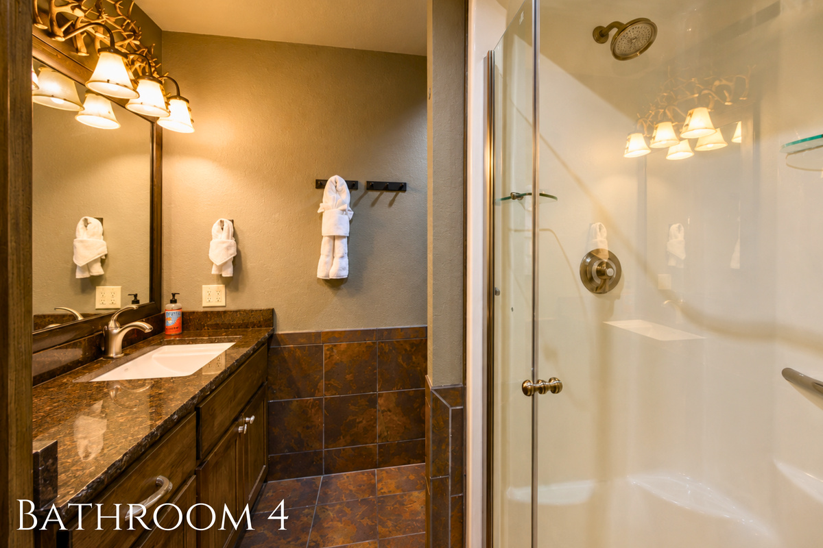 Conveniently located near the bunk spaces, this full bath includes a vanity and glass shower to help make busy mornings a little easier for larger groups.