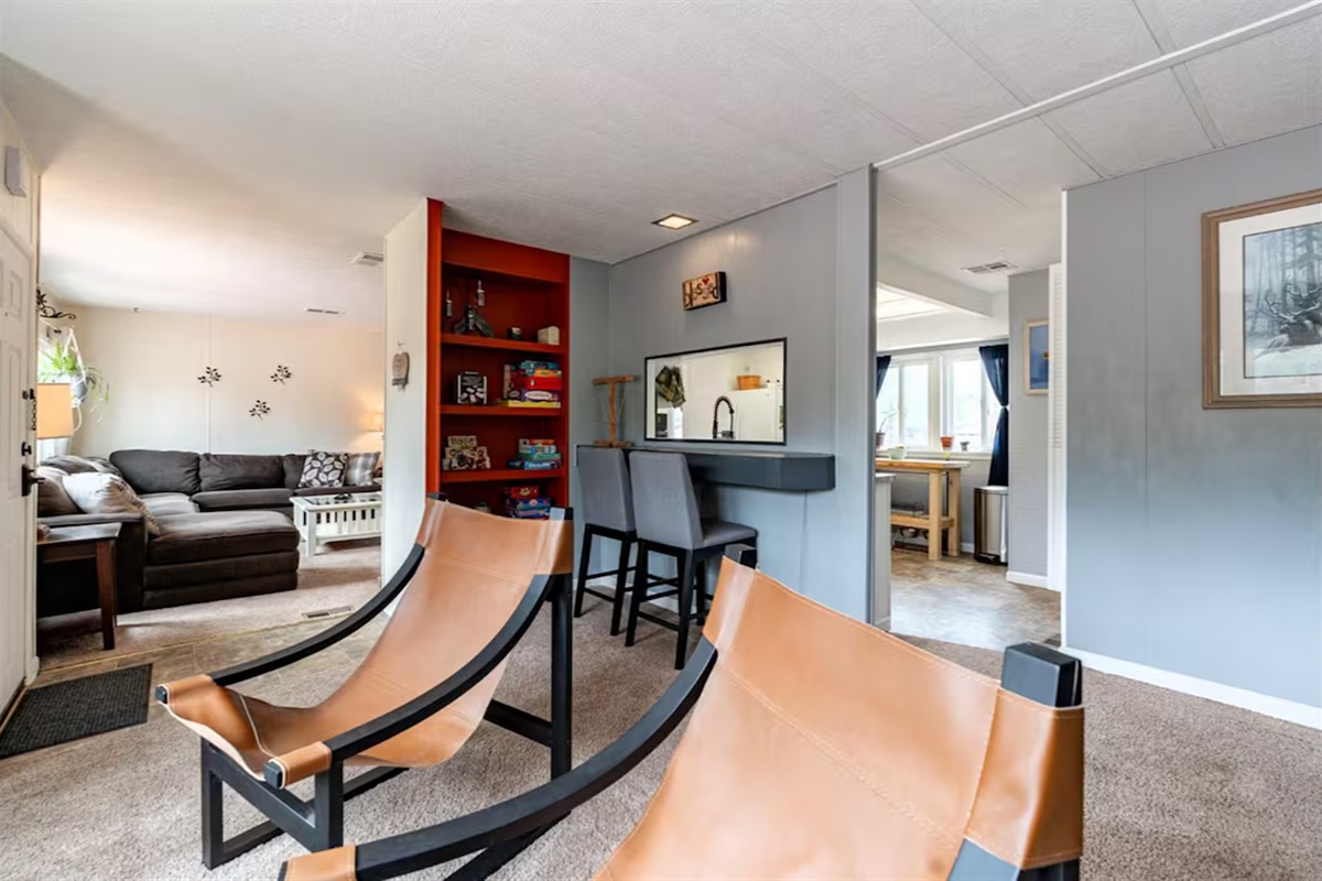 Open-concept living area with plenty of space to relax or gather together. Features bar seating and a convenient kitchen pass-through just off the front room.