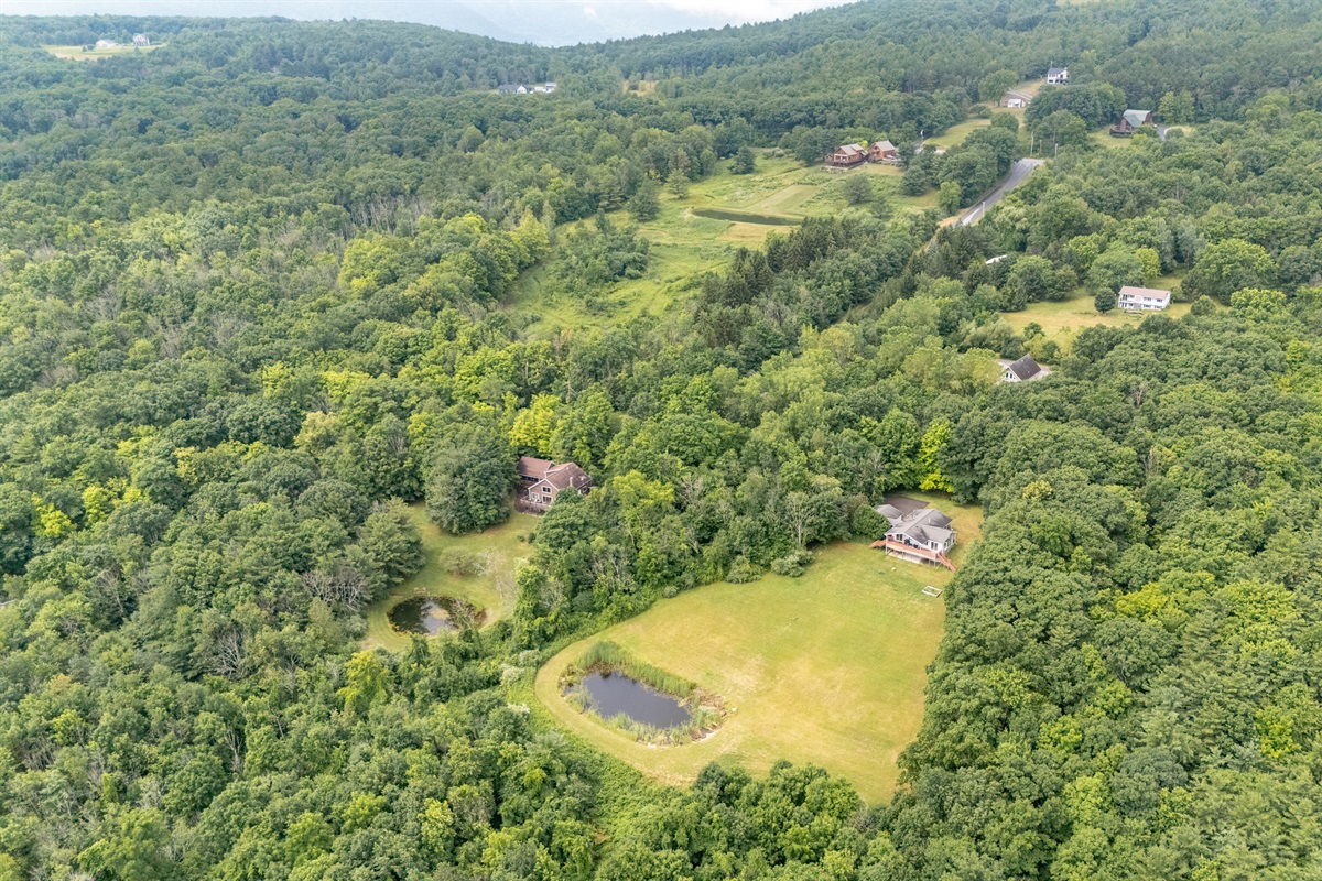 Sweeping views of wooded hills and distant homes give this property a private yet community-connected feel—ideal for peaceful living