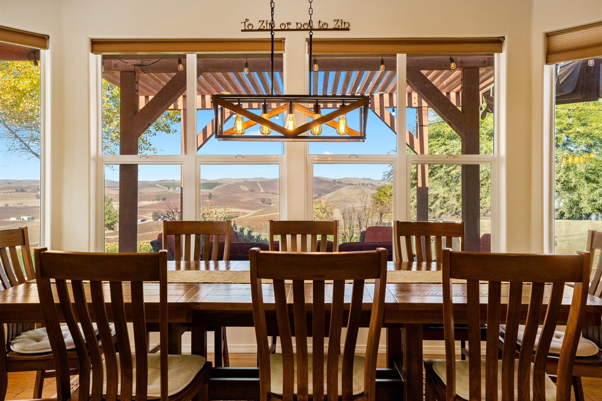 Enjoy panoramic views of the vineyards at an elegant dining table that seats 8 comfortably.