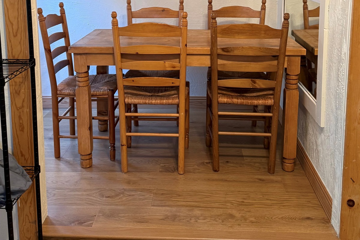 Cozy dining nook with seating for four, ideal for shared meals or use as a dedicated workspace during your stay.