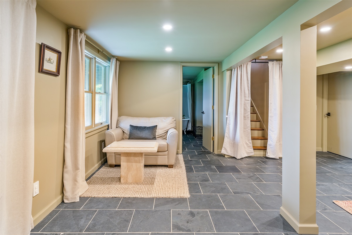 Wake up to stunning views from this walkout lower level bedroom suite with private sitting area and patio access.