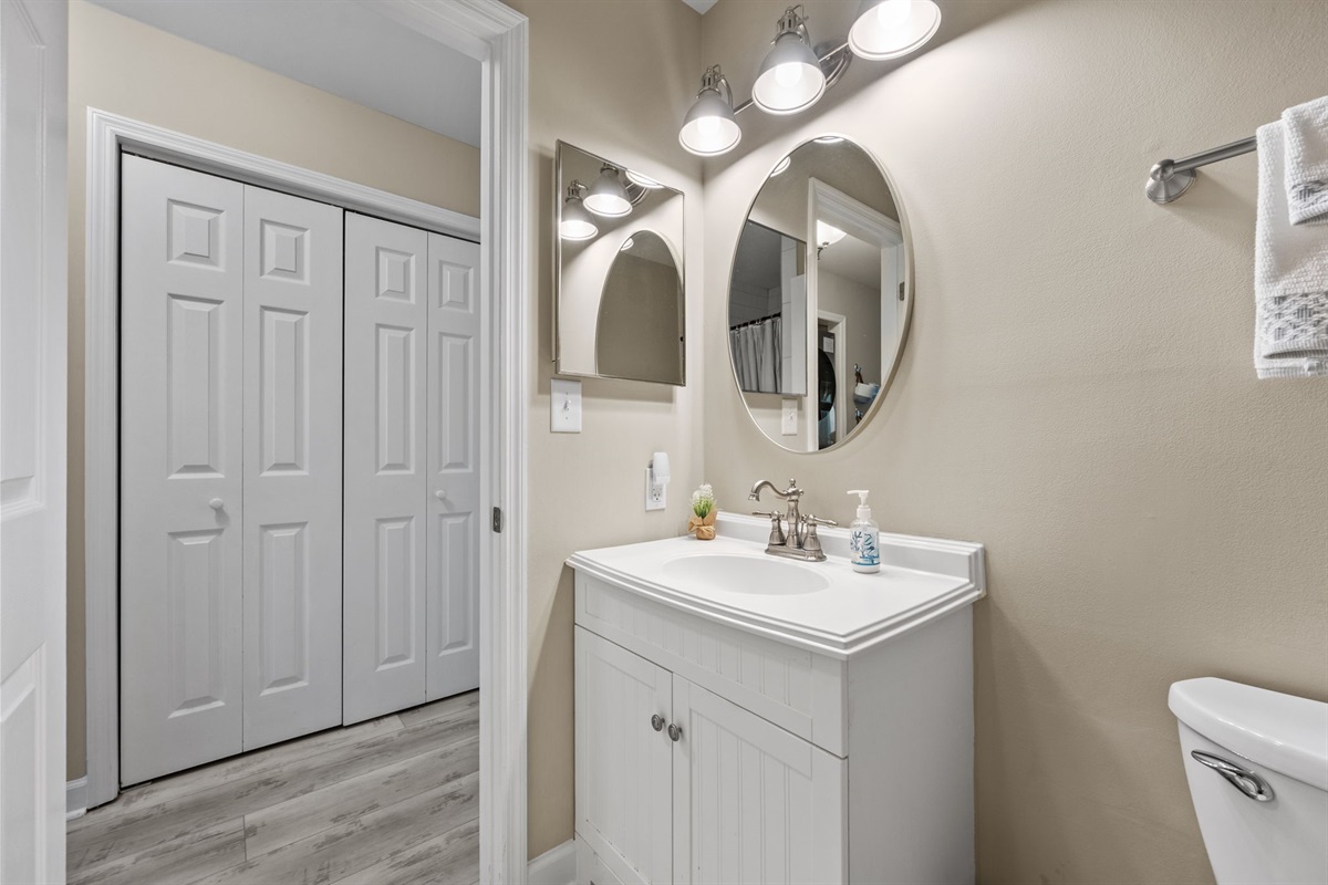 Ensuite bathroom for the second master, featuring a bright vanity, modern lighting, and a clean coastal feel