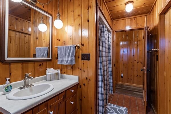 Bath 1 is located on the main level next to the bedrooms and has a shower/tub.