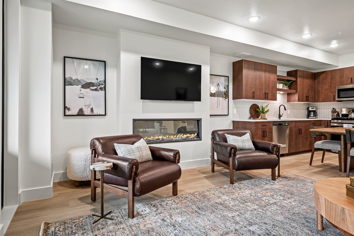 Relax in plush leather chairs by the fireplace, complete with a wall-mounted TV for movie nights.