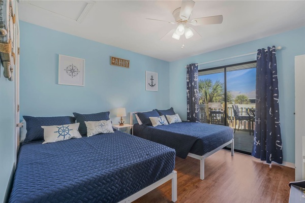 Second bedroom with 2 full size beds and a view that overlooks the pools.