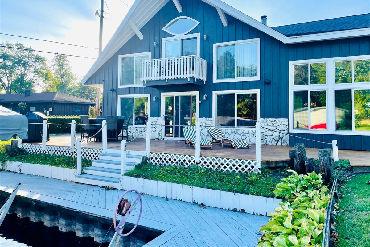 Lakefront exterior view of the home with private dock access.