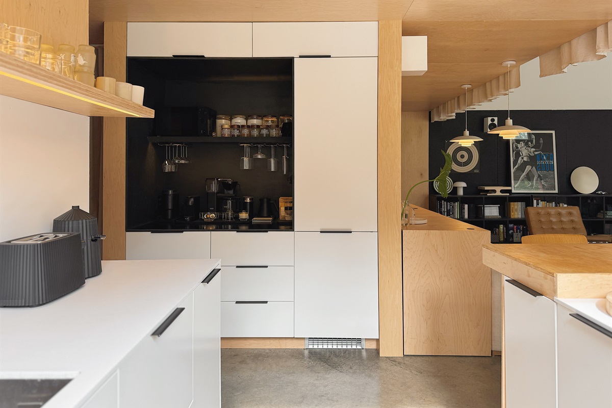 Kitchen with built-in refrigerator and coffee bar.