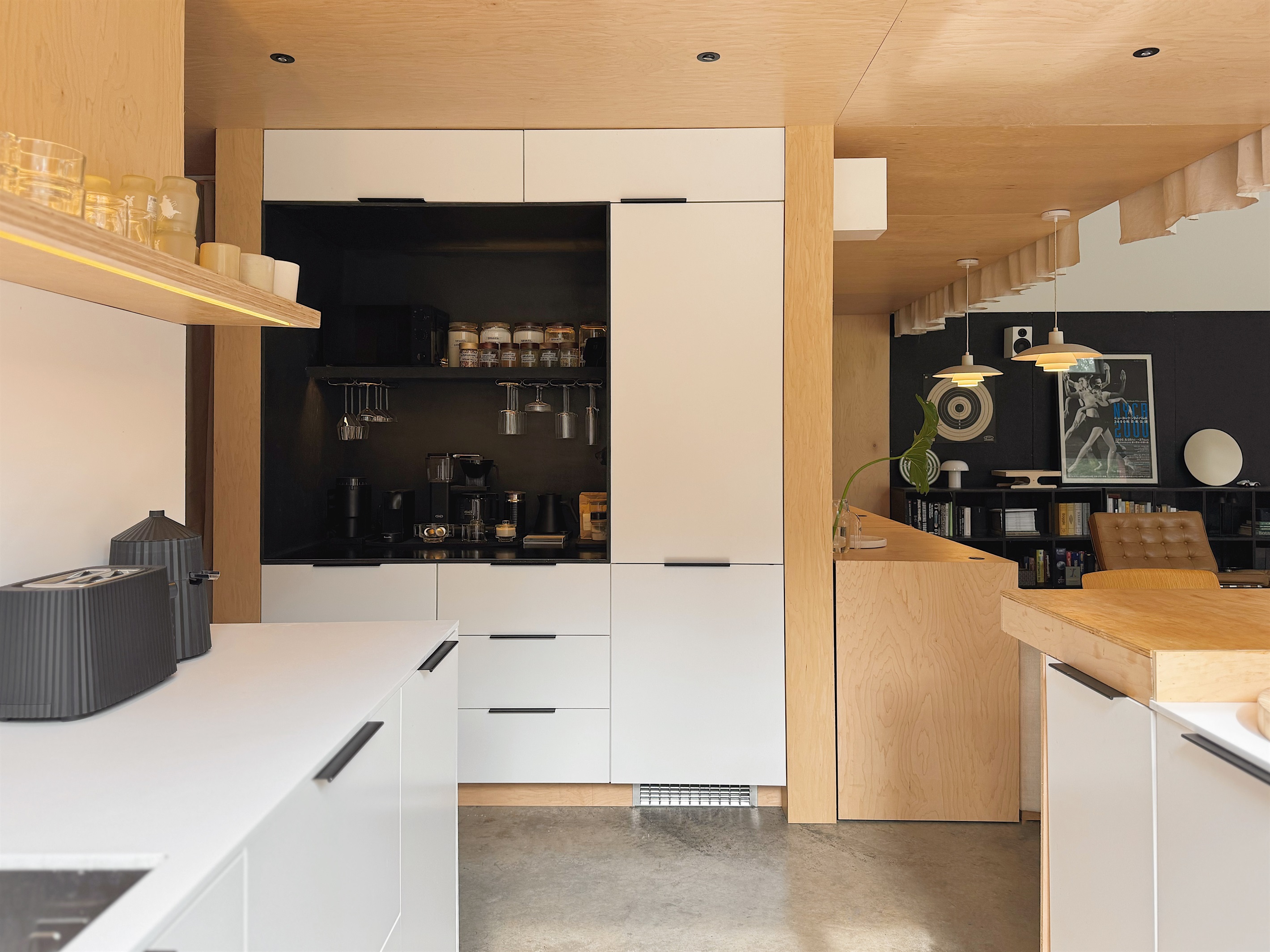 Kitchen with built-in refrigerator and coffee bar.