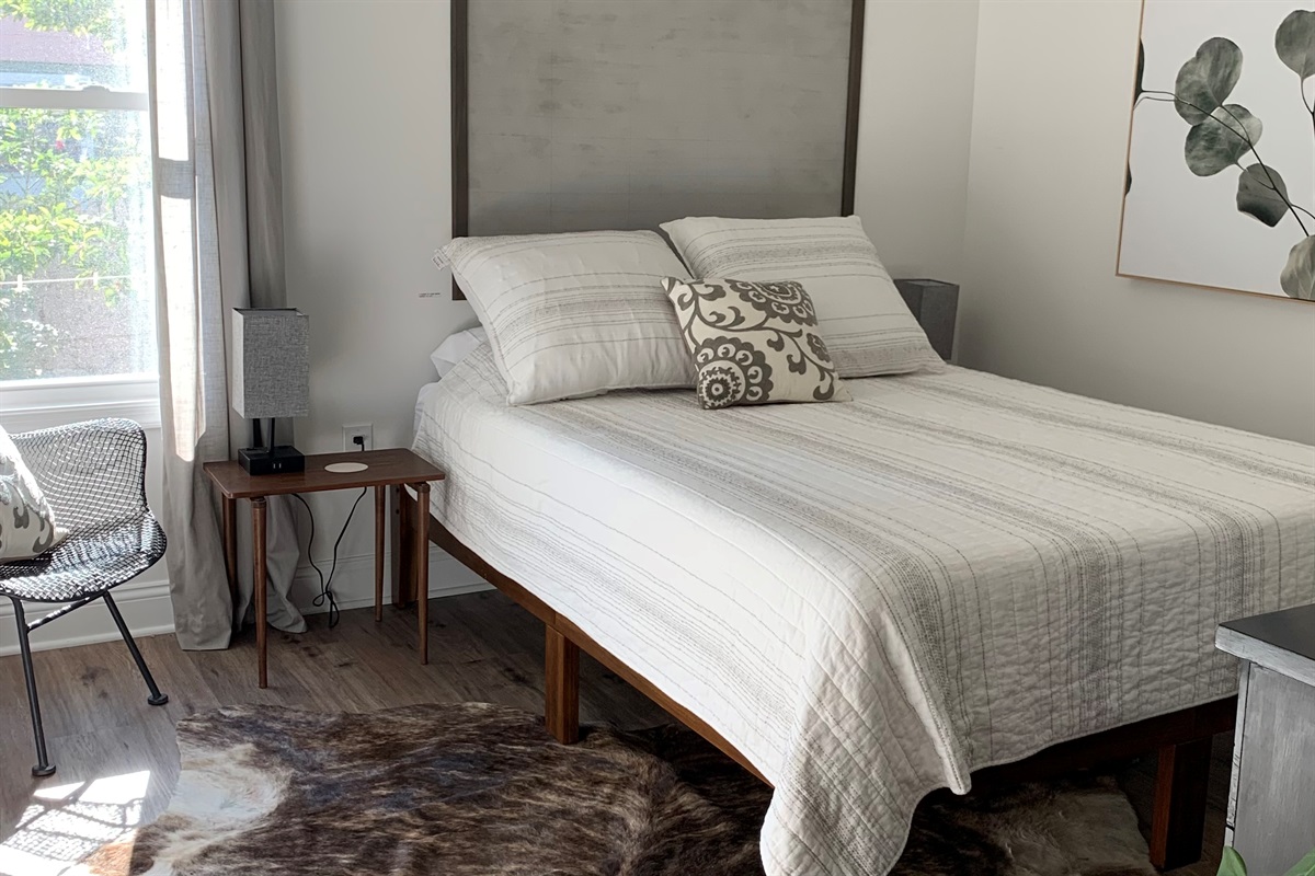 Bedroom 1 features a queen bed, smart tv, and drapes to block the morning light if you want to sleep in