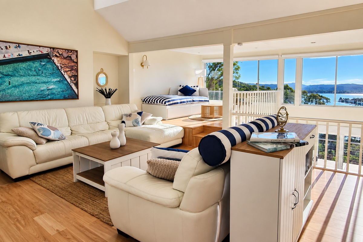 Relax in the sun-filled living area while enjoying panoramic water and mountain views through expansive windows.