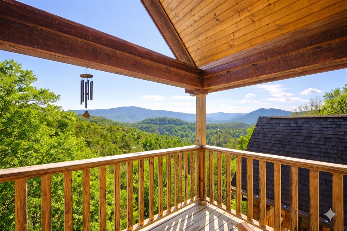 Step out onto the balcony and let the mountain air refresh your spirit. The gentle sound of the wind chime and panoramic Smoky Mountain views make this the perfect spot to unwind at sunset.