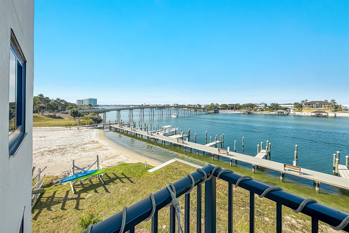 Your perfect waterfront retreat awaits. The stunning vista of the Ono Island Bridge and private marina on Ole River, offered exclusively at Wind Drift. Discover coastal living at its finest