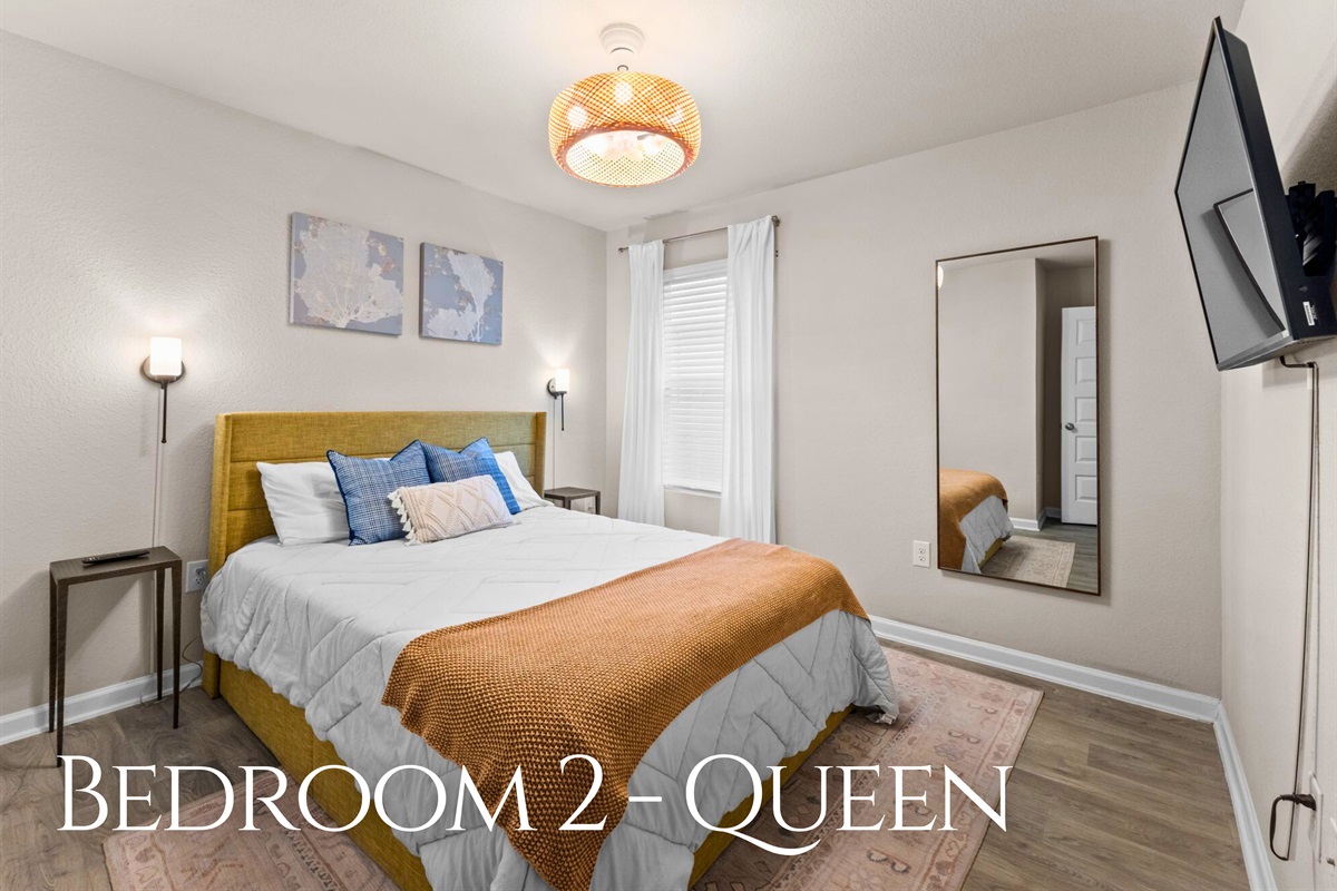 The second bedroom features a cozy queen bed and a calm, comfortable atmosphere that’s perfect for a good night’s rest.