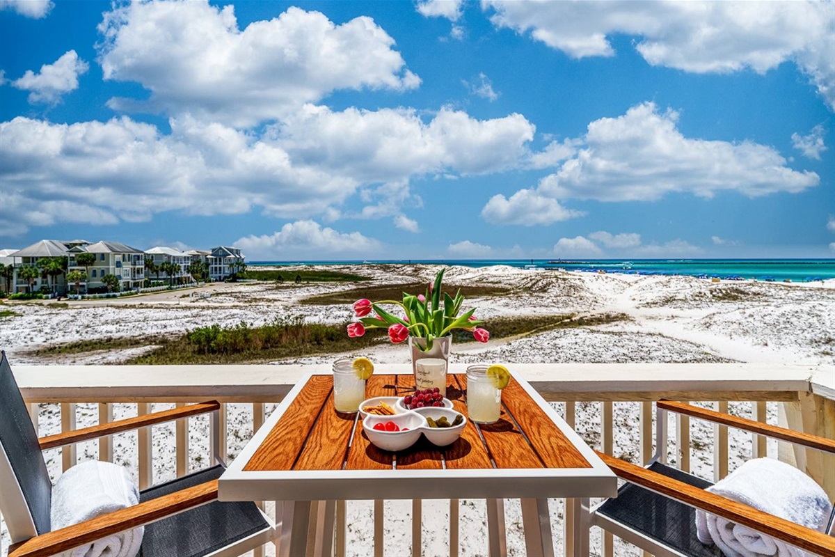 Dine with the best view in Destin. The Perch's deck table seats four with direct views of the Gulf, white sand dunes, and endless blue sky