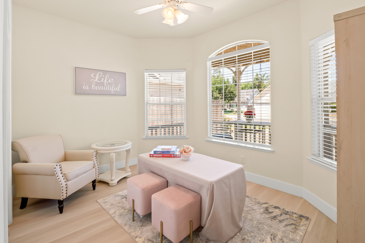 Enjoy a peaceful retreat in this charming bonus room, thoughtfully designed for relaxation, games, reading, or quiet conversation. Large windows fill the space with natural light, creating a bright and welcoming atmosphere.