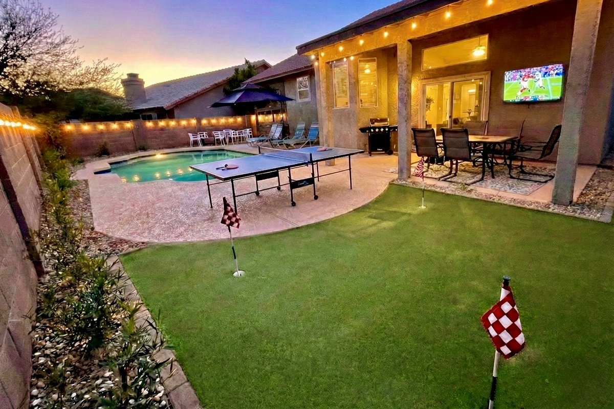 Large, fenced backyard has a swimming pool (can be heated for add'l fee), putting green, ping pong, dining table, TV, & propane grill. Not pictured: hot tub, and gas fire pit.
