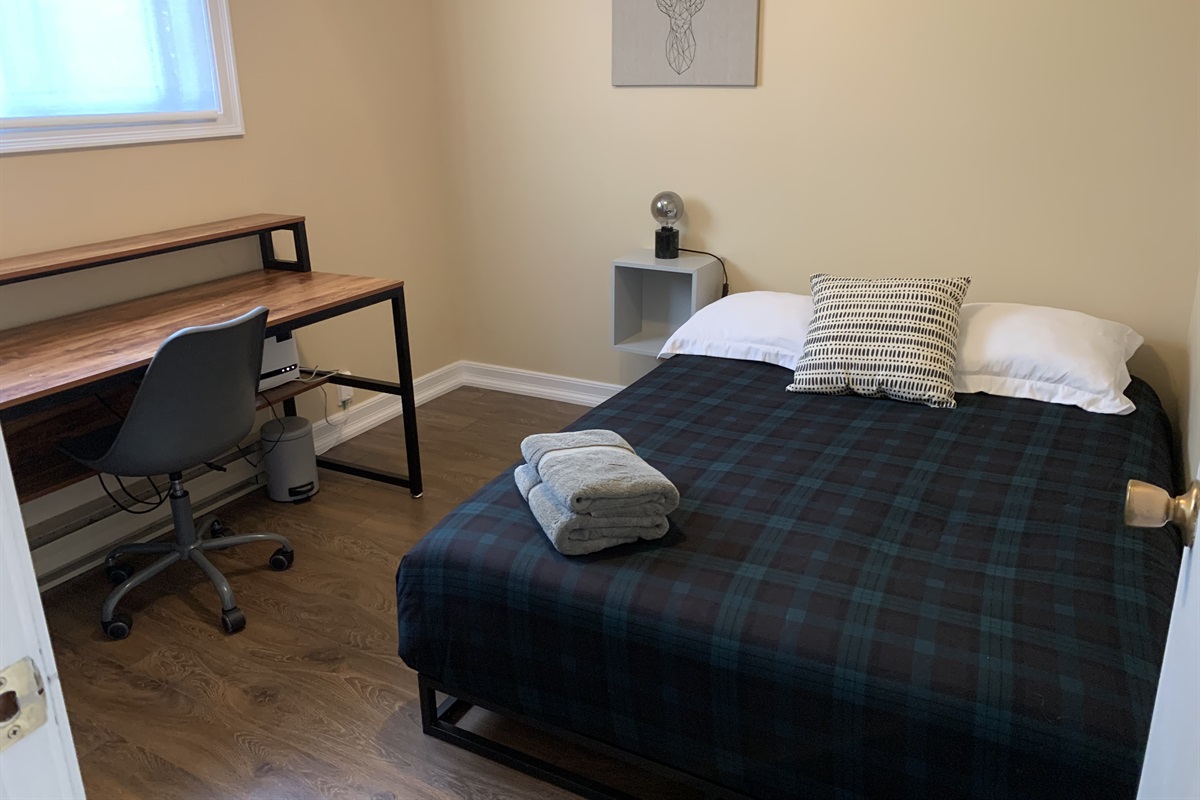 Bedroom two/office with queen-sized bed and desk and work area
