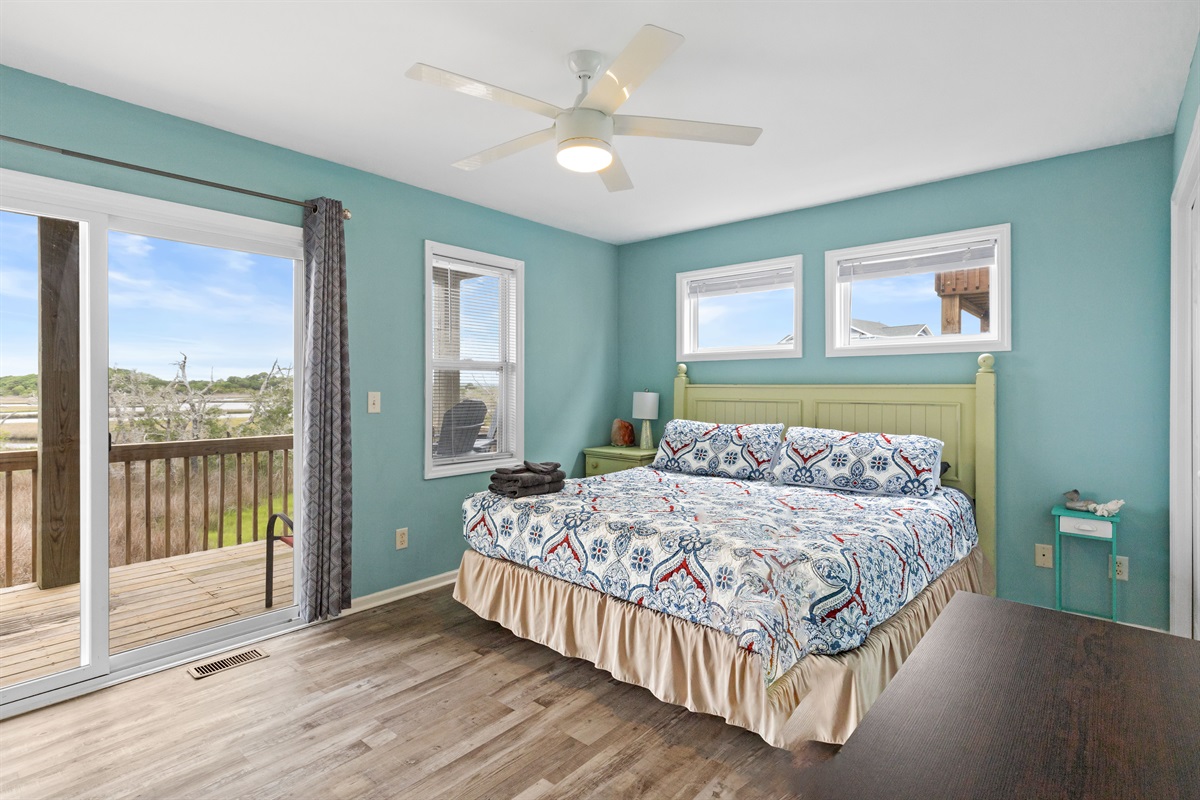 Spacious master suite with private balcony access and peaceful views