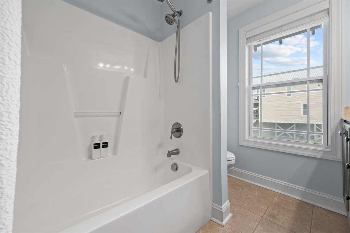 2nd full bathroom offers a tub/shower combo, hand held shower head, and vanity with ample storage 