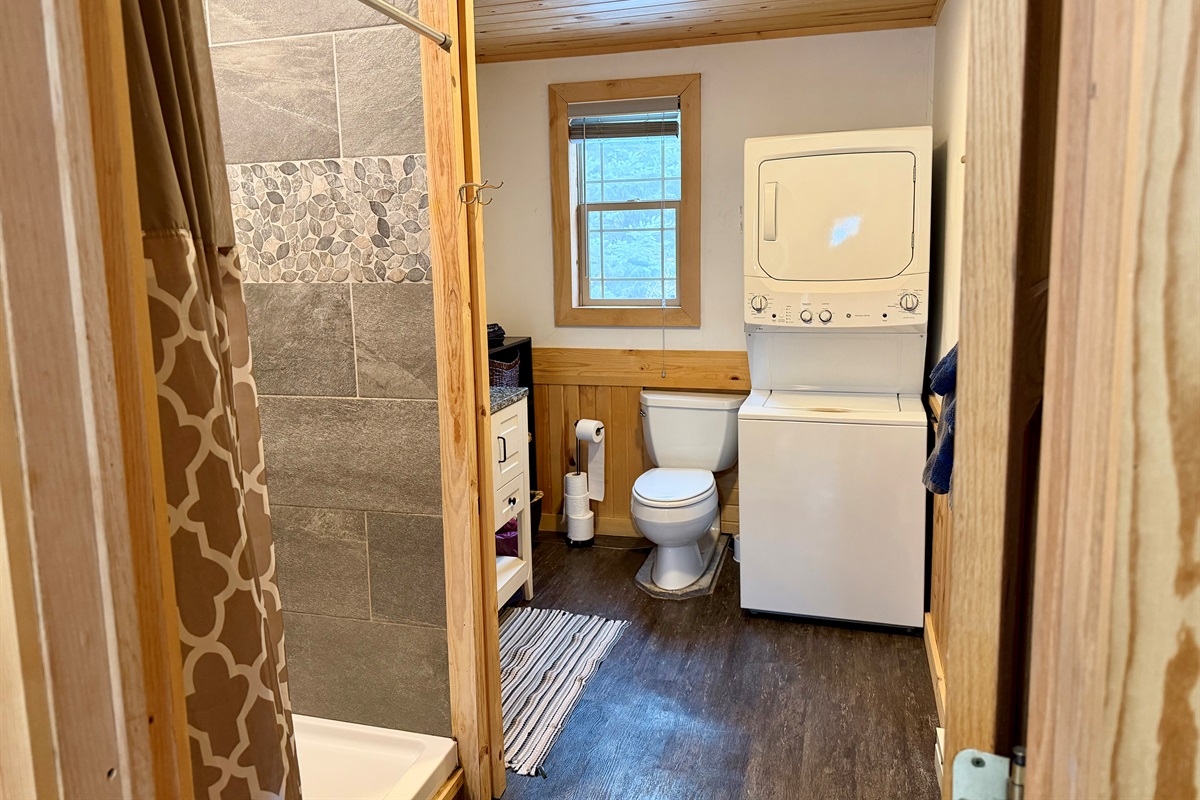 Bright, updated bathroom that is clean, fresh, and modern. Includes a convenient stacked washer/dryer right in the space, making it easy to refresh towels and gear during your stay.
