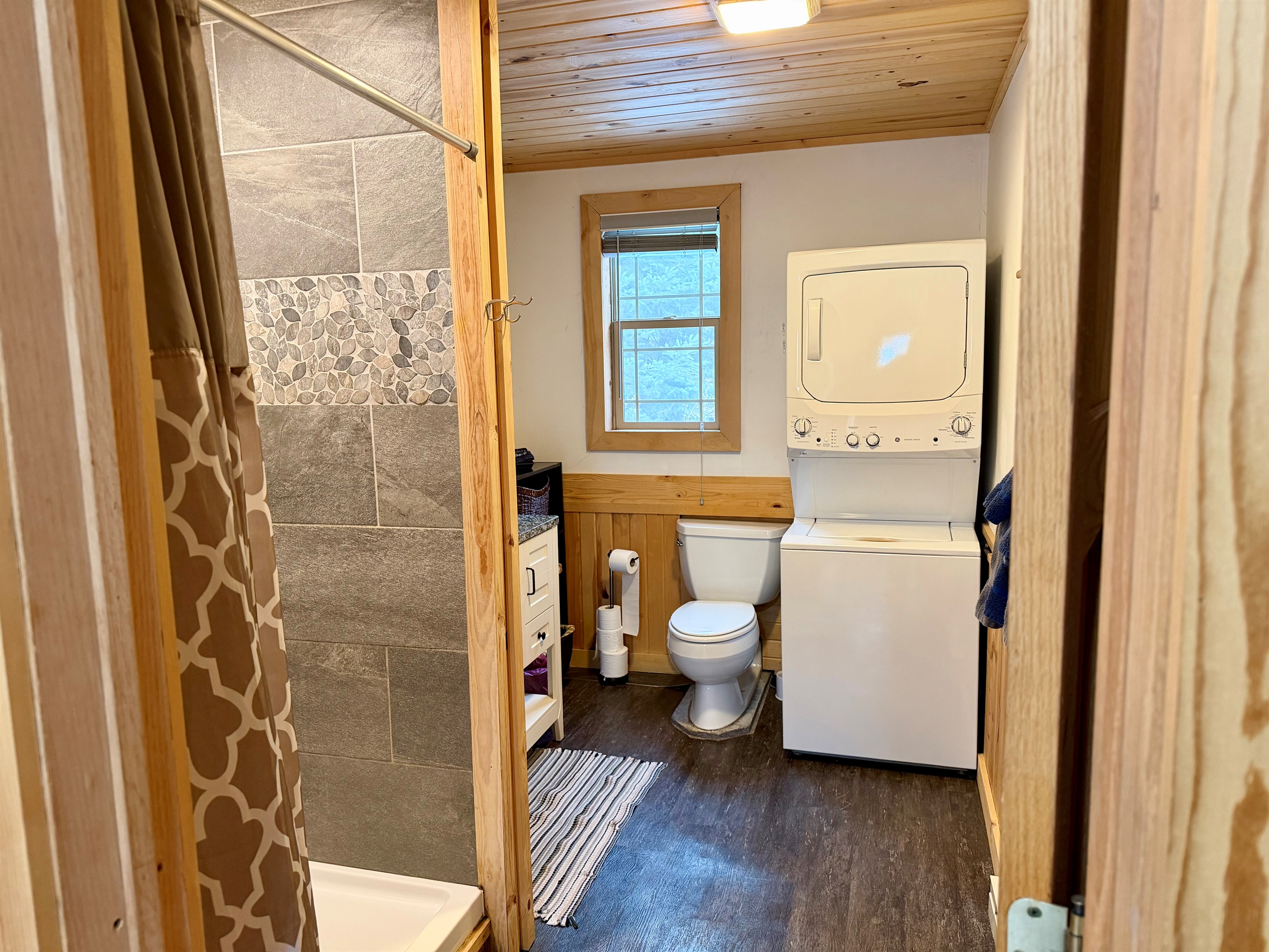 Bright, updated bathroom that is clean, fresh, and modern. Includes a convenient stacked washer/dryer right in the space, making it easy to refresh towels and gear during your stay.