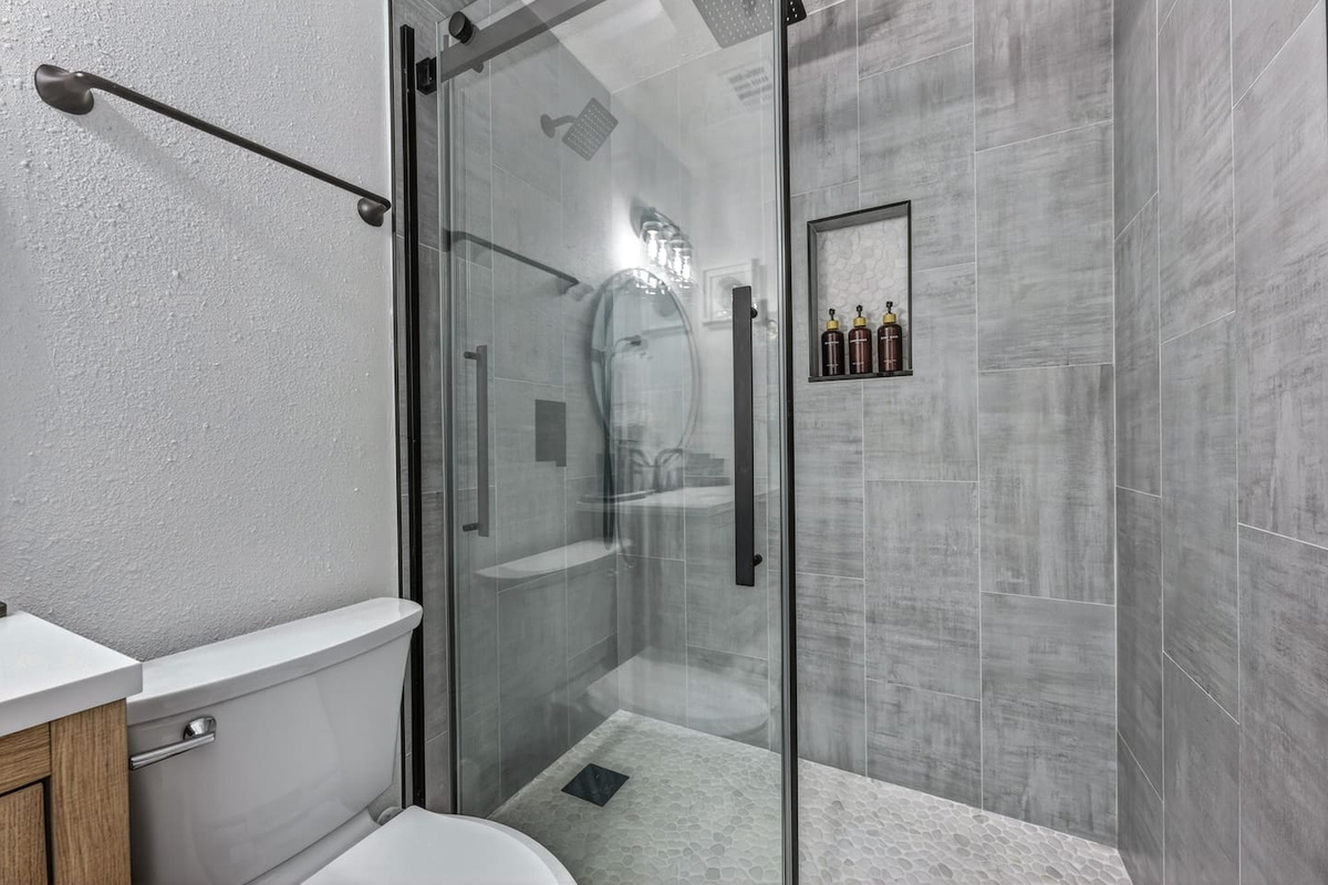 Modern bathroom featuring a walk-in shower and complimentary bathroom essentials for a comfortable stay