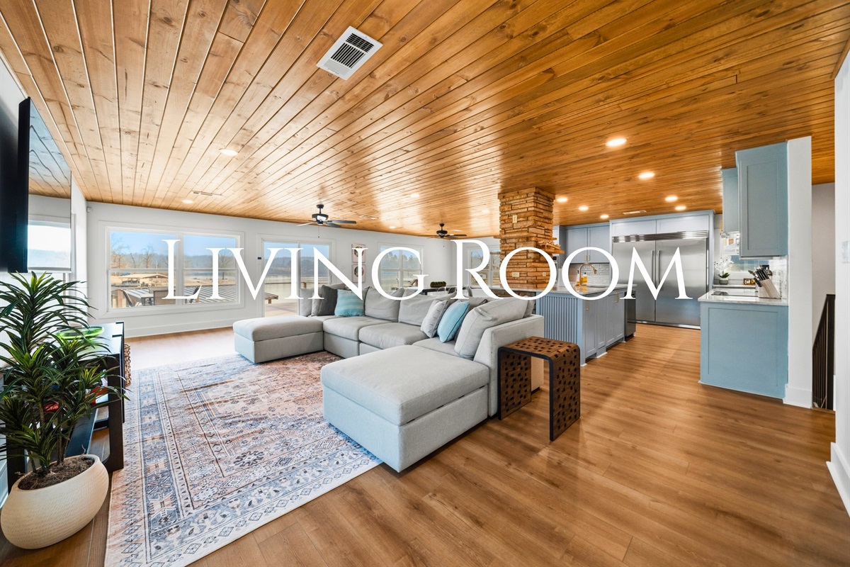 The living room offers plenty of cozy seating, making it the perfect place to unwind, watch a movie, or gather for conversation while natural light fills the space.
