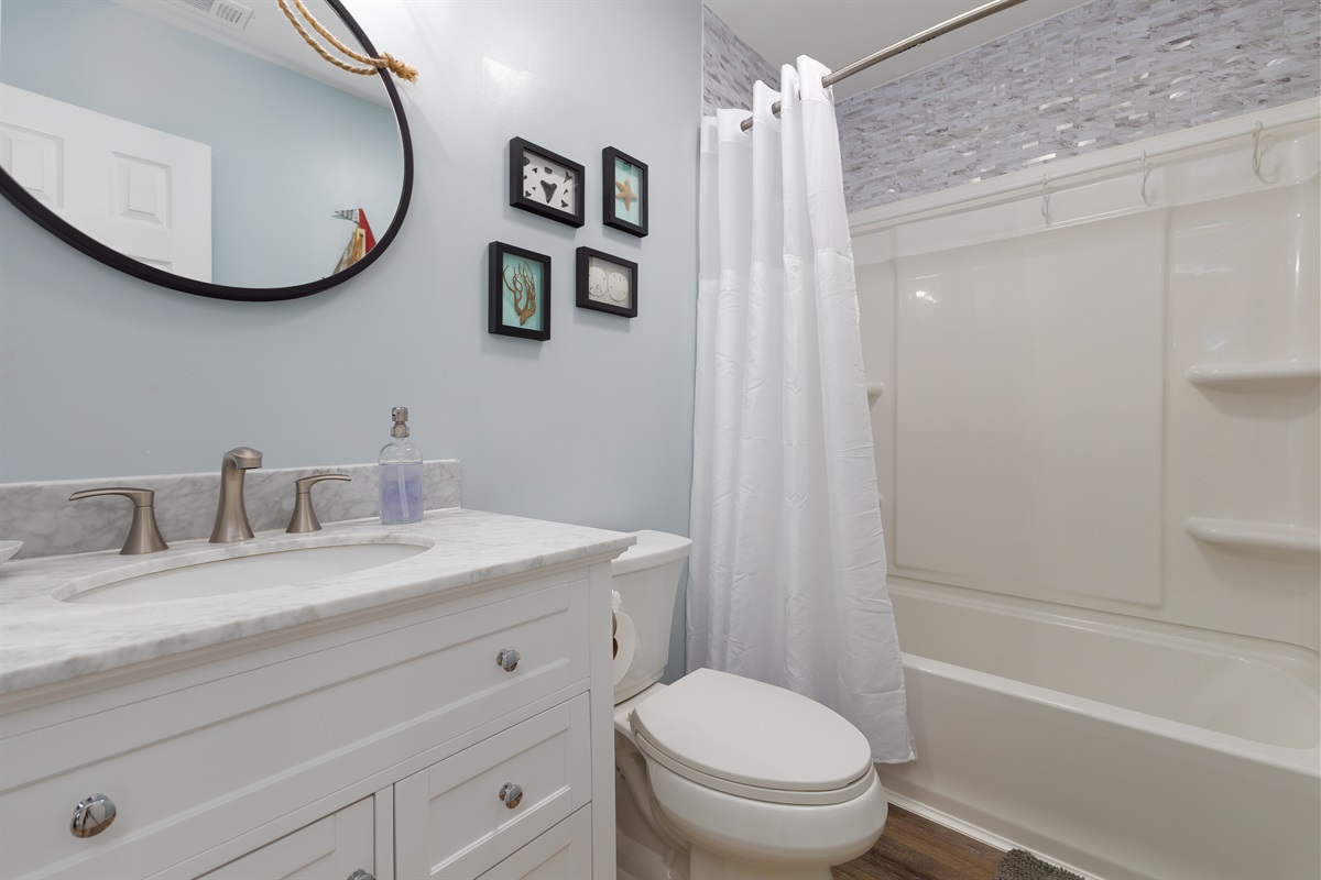 Upsatairs bathroom fatures a combination of tub/shower