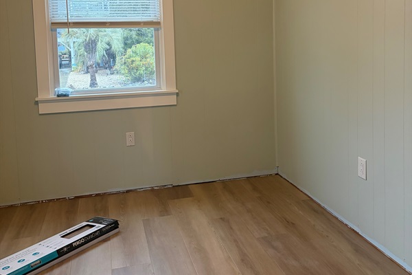 Bedroom walls are painted, crown installed and flooring is started!