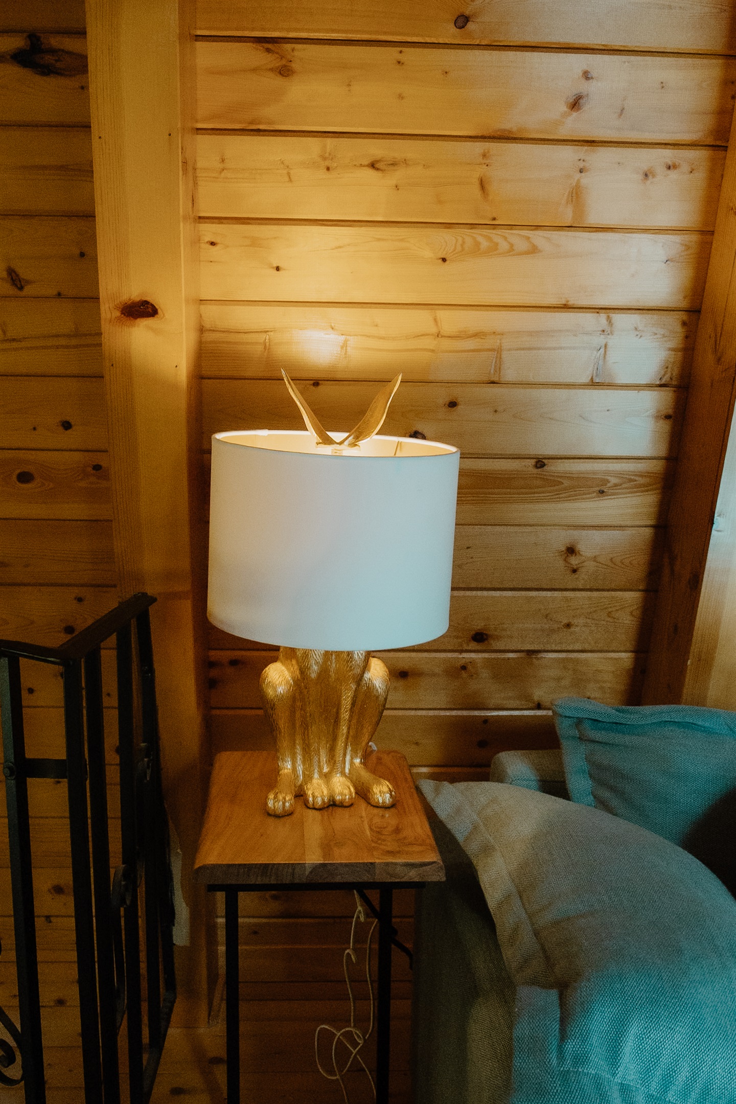Warm lighting and curated décor elevate the loft lounge of this A-frame cabin. From the vaulted wood ceilings to cozy seating, every detail invites relaxation in this peaceful Show Low mountain escape.