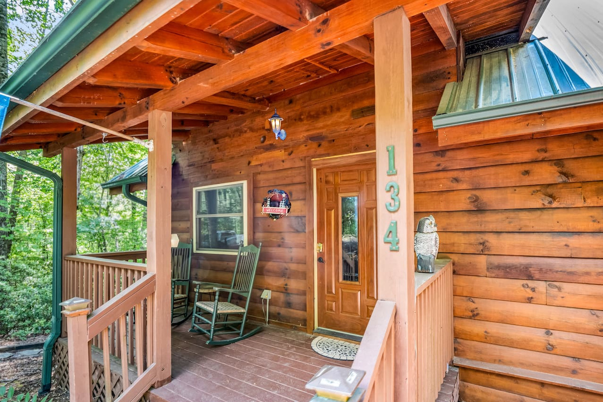 Cozy front entrance to the cabin, surrounded by wooded areas