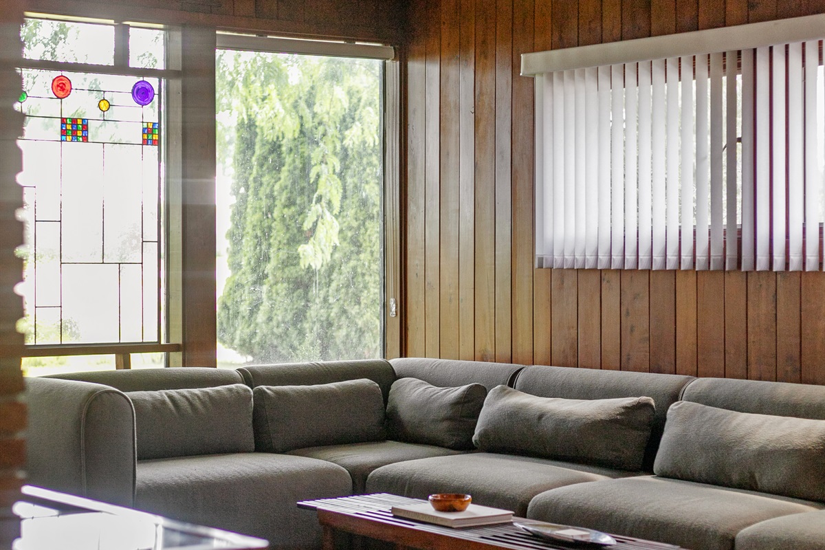 Large windows fill the living room with natural sunlight, creating a bright and welcoming space to relax throughout the day.