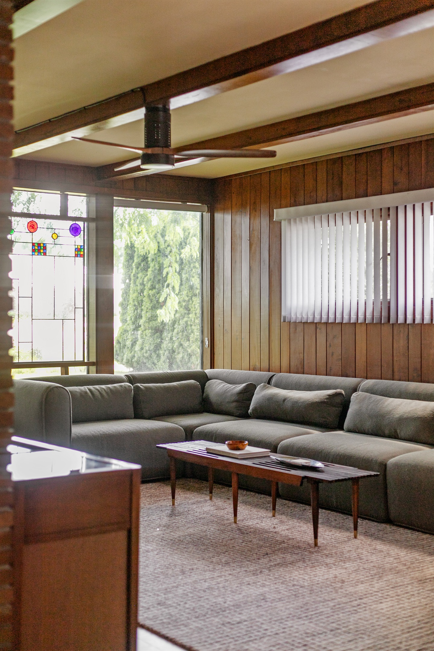 Large windows fill the living room with natural sunlight, creating a bright and welcoming space to relax throughout the day.