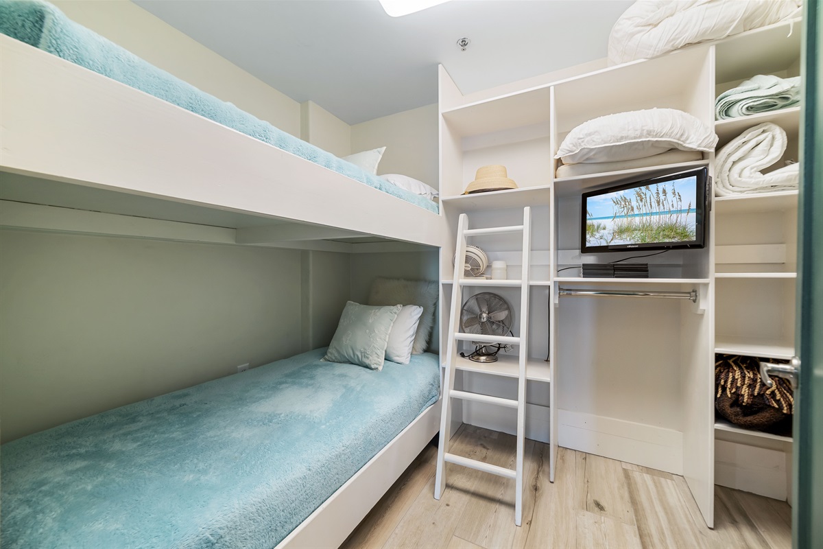 Versatile bunk bed room offering comfortable accommodations for guests or family. This space maximizes functionality and style, providing a cozy and inviting atmosphere.