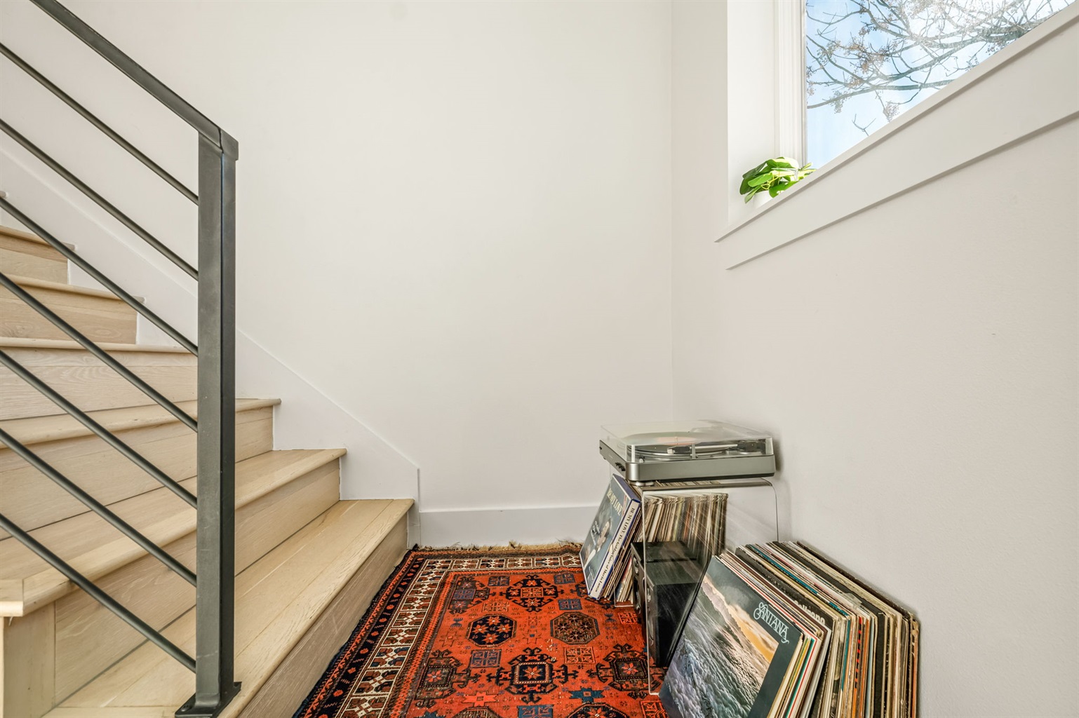 Discover a cozy stairway nook, perfect for unwinding with music and vinyls