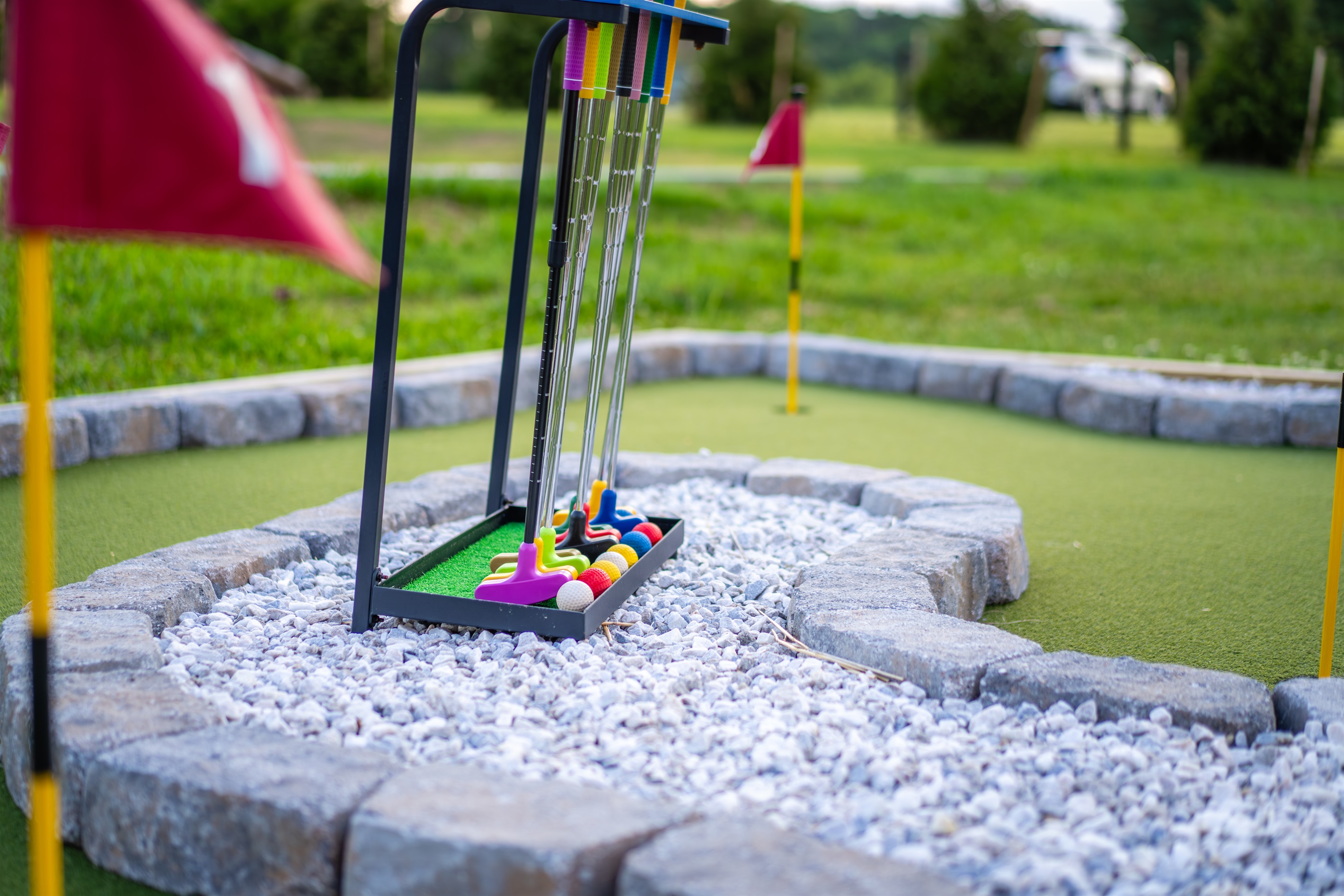 Kids and adults compete on the backyard putting green. Low stakes, big laughs. The mini-golf hole is never empty for long.