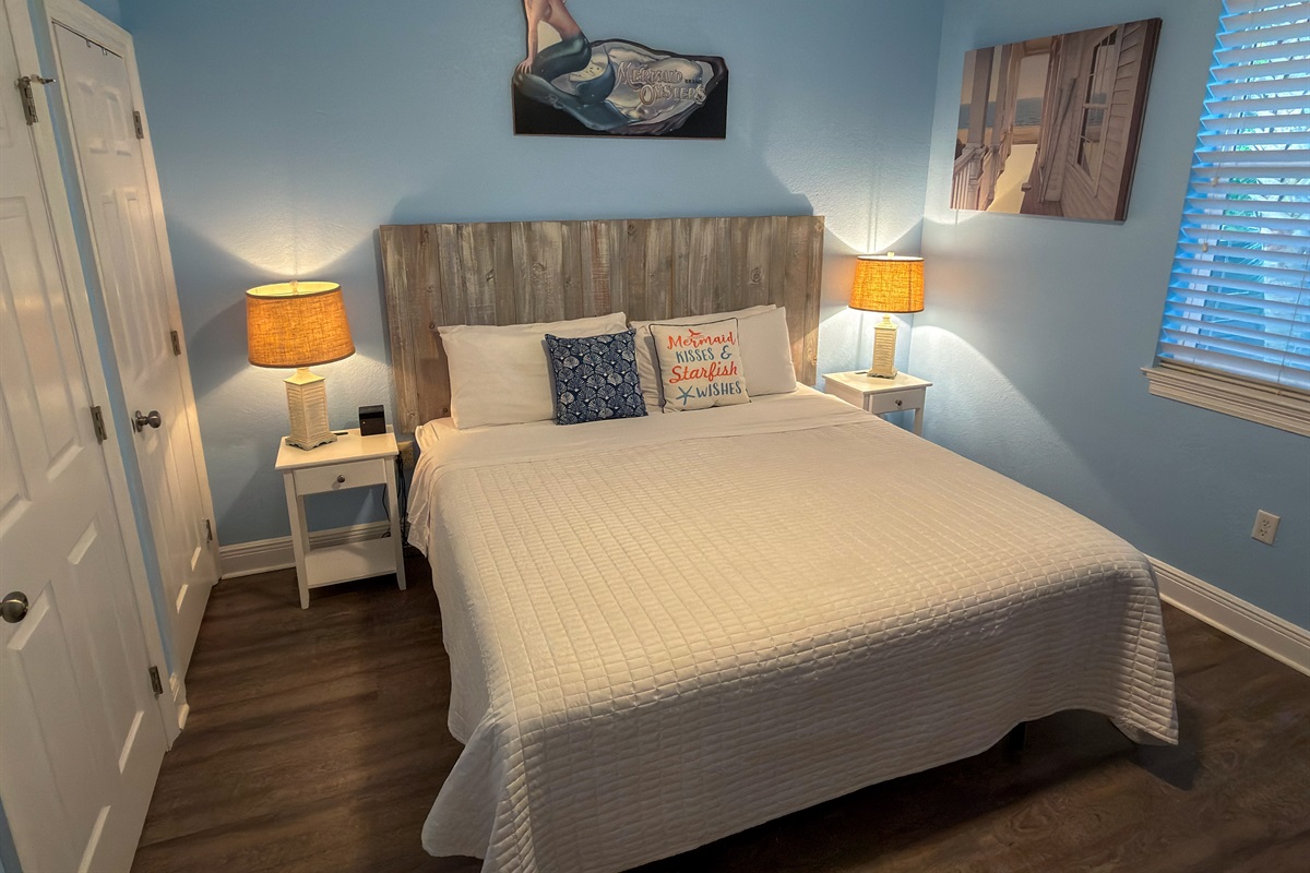 First Floor Bedroom 1 offers a peaceful coastal escape with soft blue tones, warm lighting, and soothing comfort.