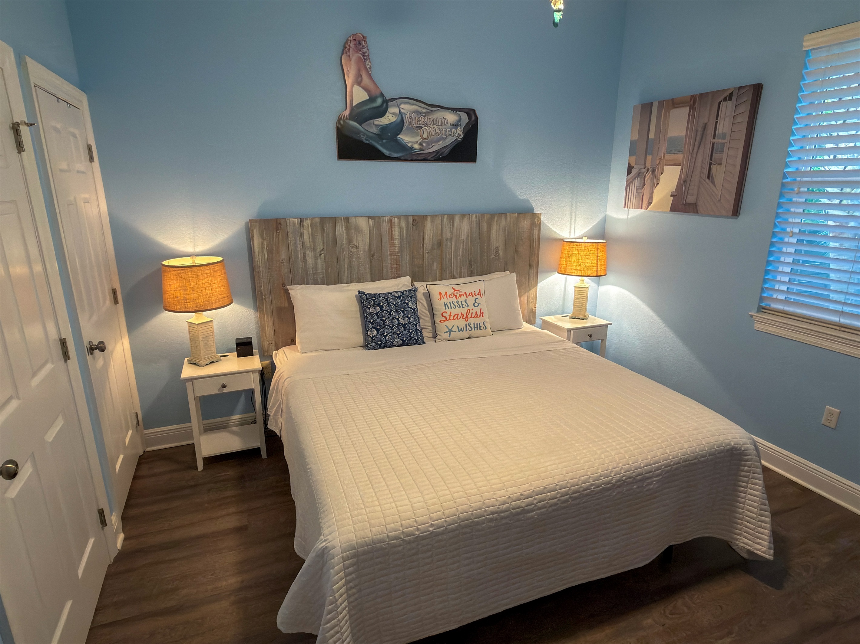 First Floor Bedroom 1 offers a peaceful coastal escape with soft blue tones, warm lighting, and soothing comfort.