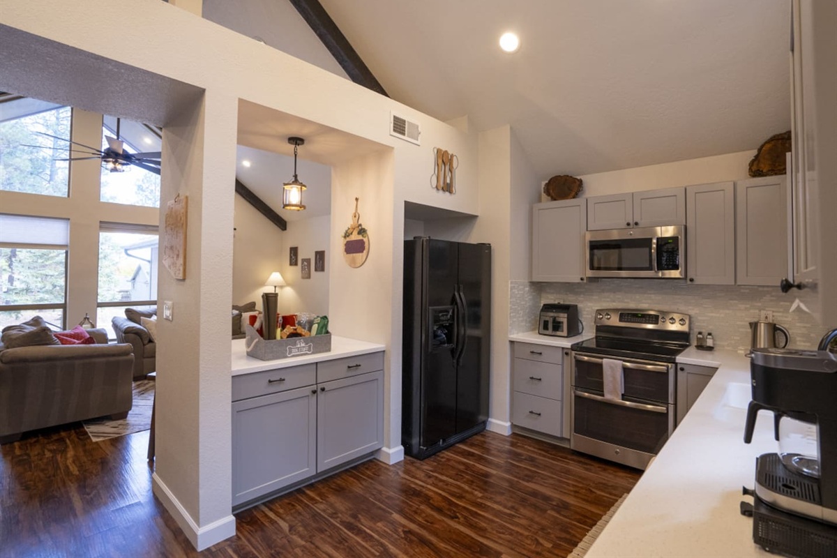 Kitchen view with full-size appliances, extra counter space, and open access to the living area.