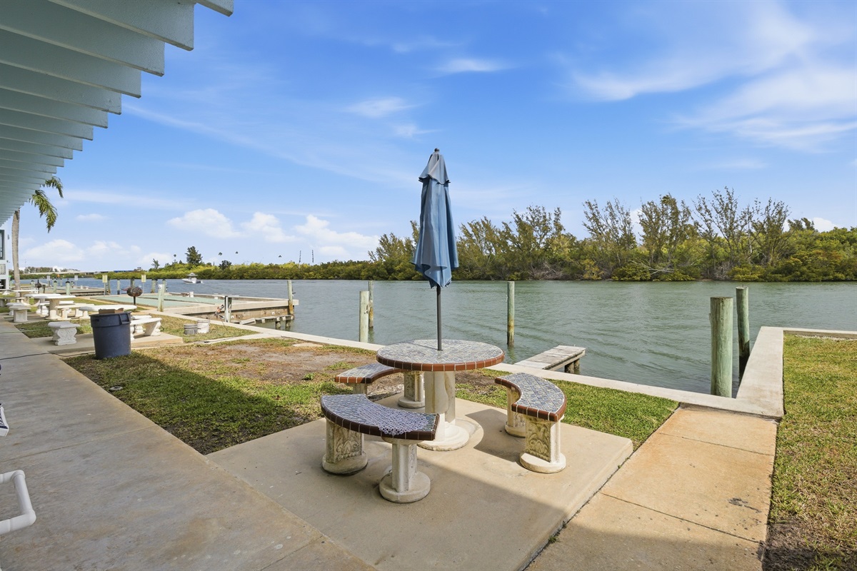 The back door of the unit opens to the Intracoastal Waterway, with a shared dining table offering stunning waterfront views!