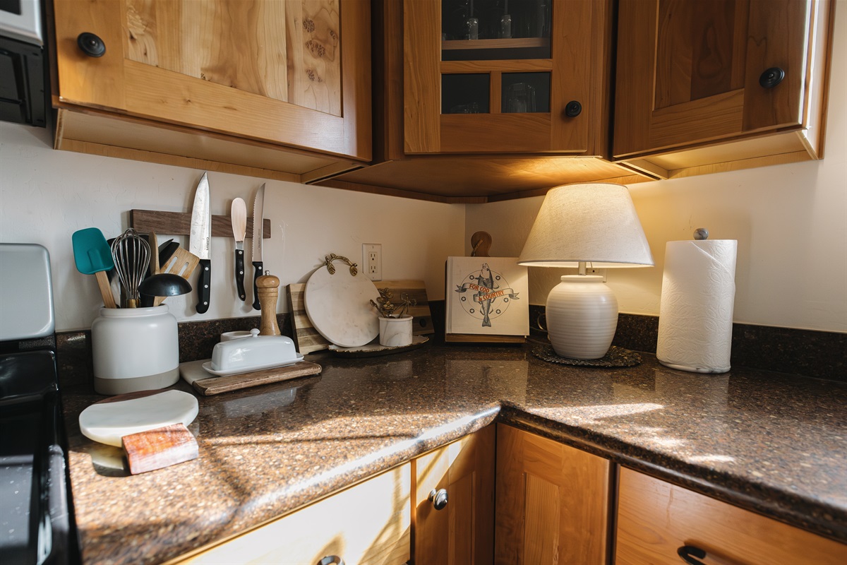 Fully stocked kitchen with warm wood cabinetry and thoughtful details—perfect for cooking meals together. Ideal for couples and families enjoying a cozy Pinetop stay near lakes and outdoor adventures.
