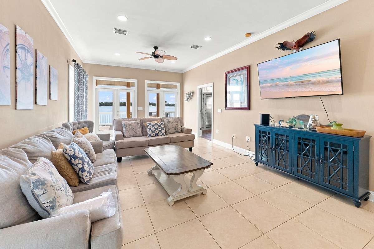 Open living room with a plush sectional and water-view windows