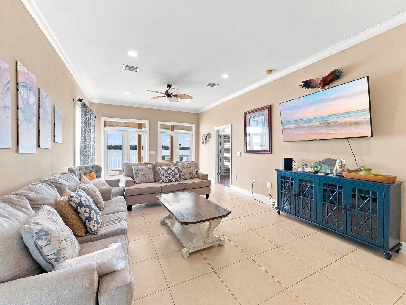 Open living room with a plush sectional and water-view windows