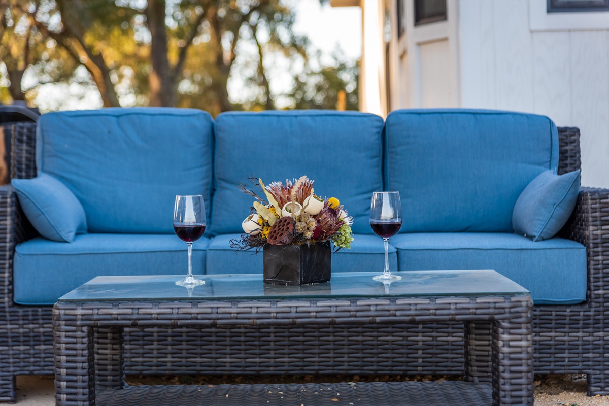 Comfortable outdoor seating and wine for the perfect relaxing afternoon.
