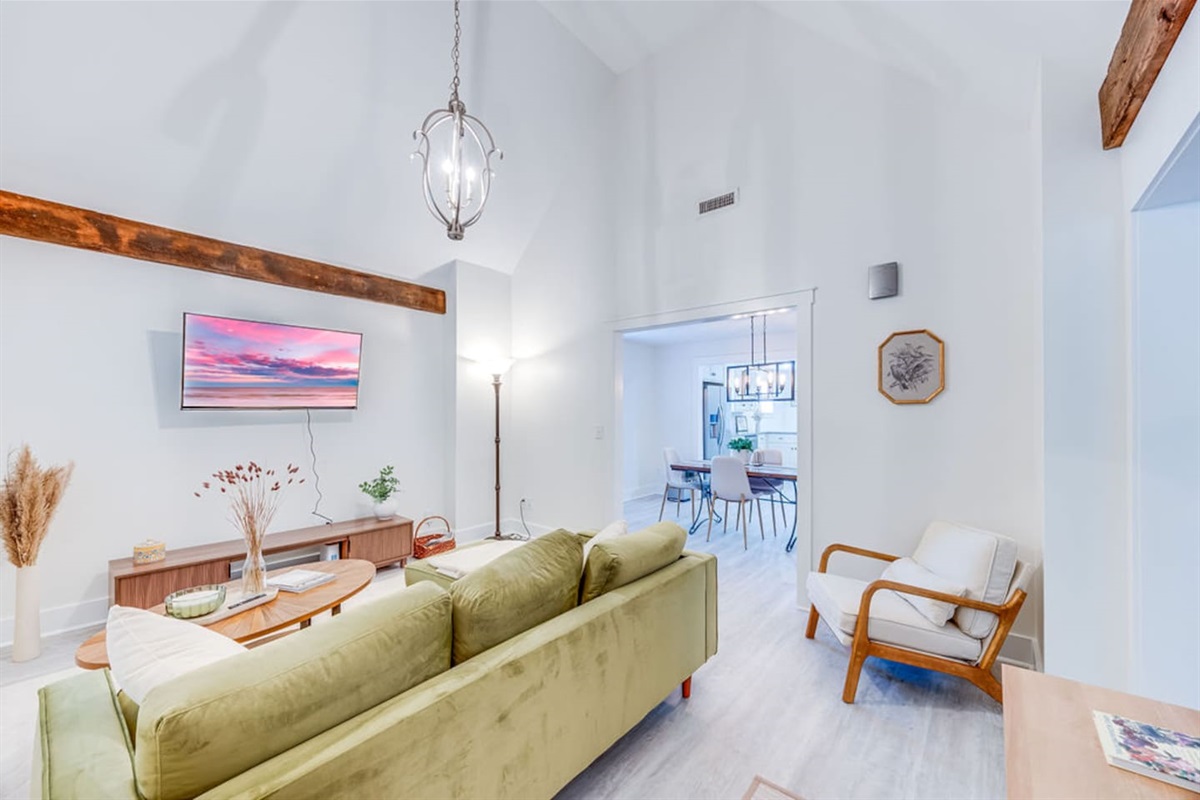 Charming living room with a cozy ambiance, featuring a comfortable sofa, soft lighting, and inviting decor for a perfect place to relax.