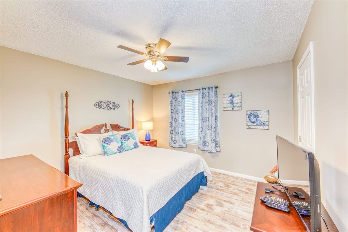 Master Bedroom: Relax in style with vibrant decor, a comfy bed, and lovely natural light!