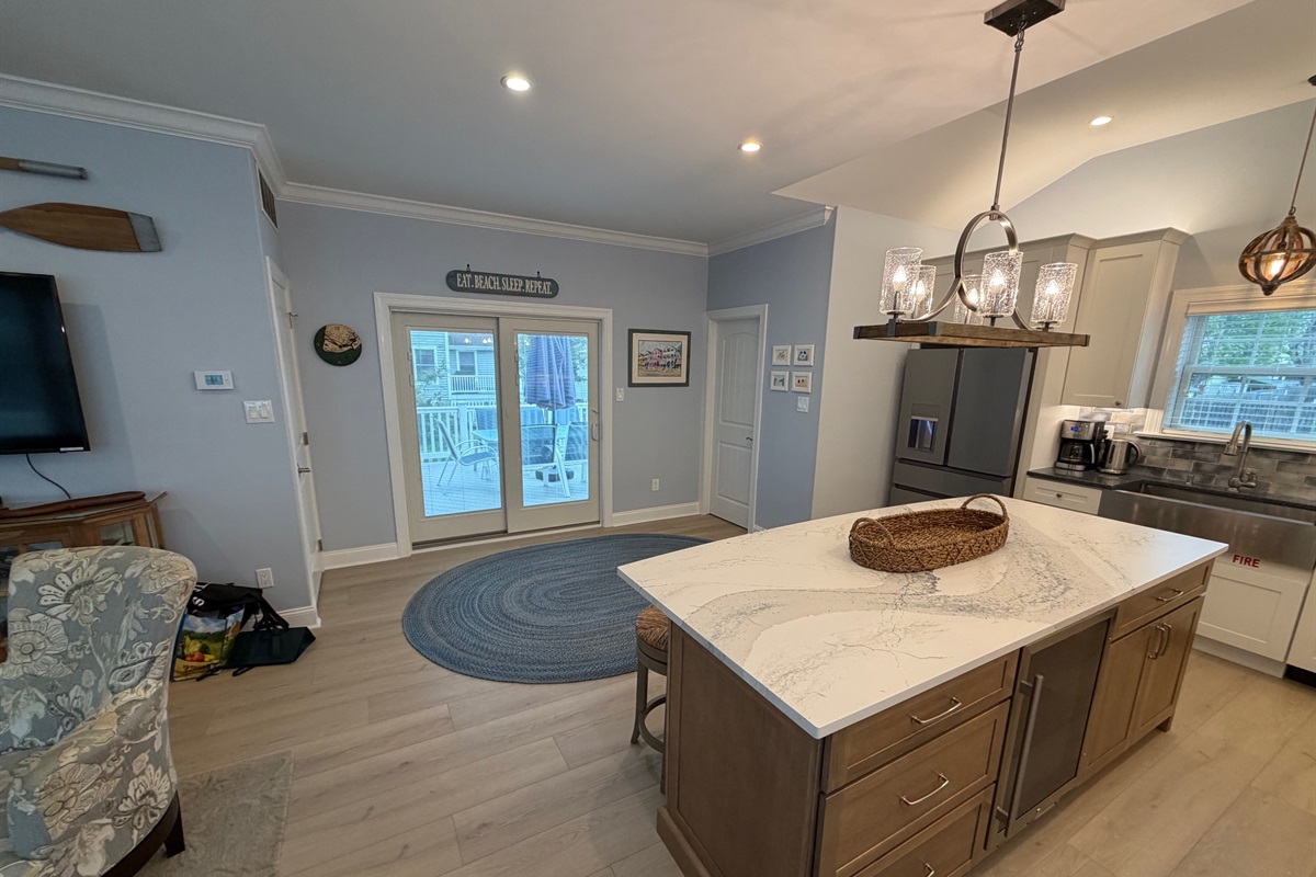 New larger kitchen with slider to the deck with powder room in the back corner.