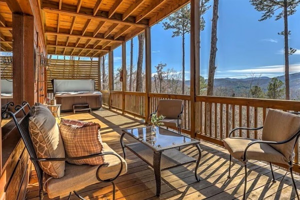 Lower-level deck with private hot tub, comfortable seating, and expansive Blue Ridge Mountain views - perfect for unwinding under the open sky.