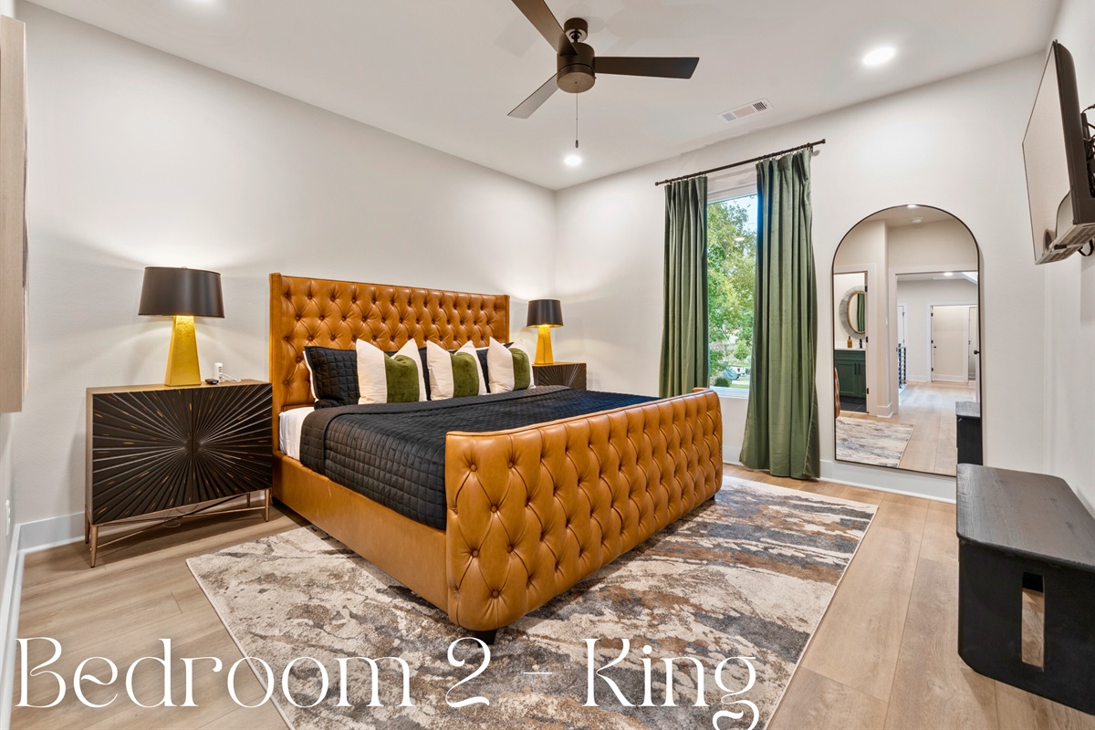 The king-sized bed, with its plush, tufted headboard, promises a comfortable and luxurious night's sleep.